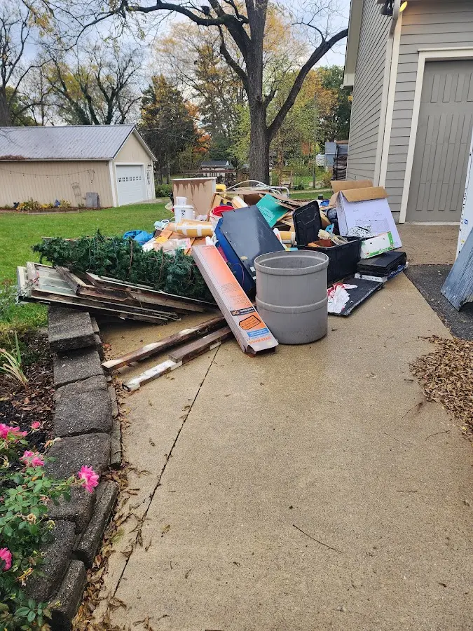 Dumpster being loaded with debris for 30 Yard Dumpster Rental in Homewood